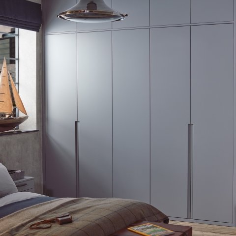 Sculpt bedroom door design with sleek handleless cabinetry and minimalist styling