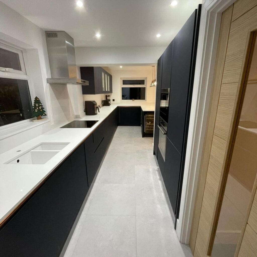 Long galley kitchen renovation by TY Home Renovations with sleek cabinetry and lighting