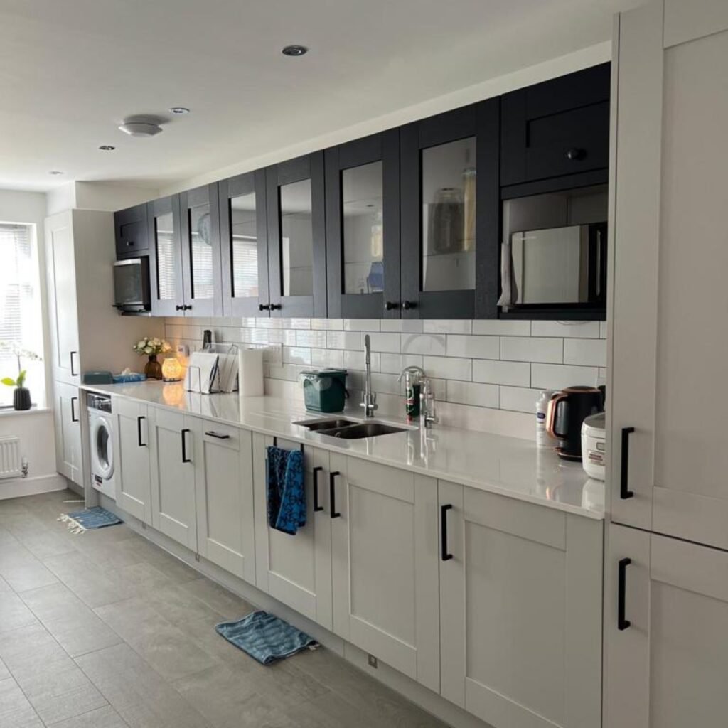 Light-coloured kitchen renovation by TY Home Renovations with tiled splashback