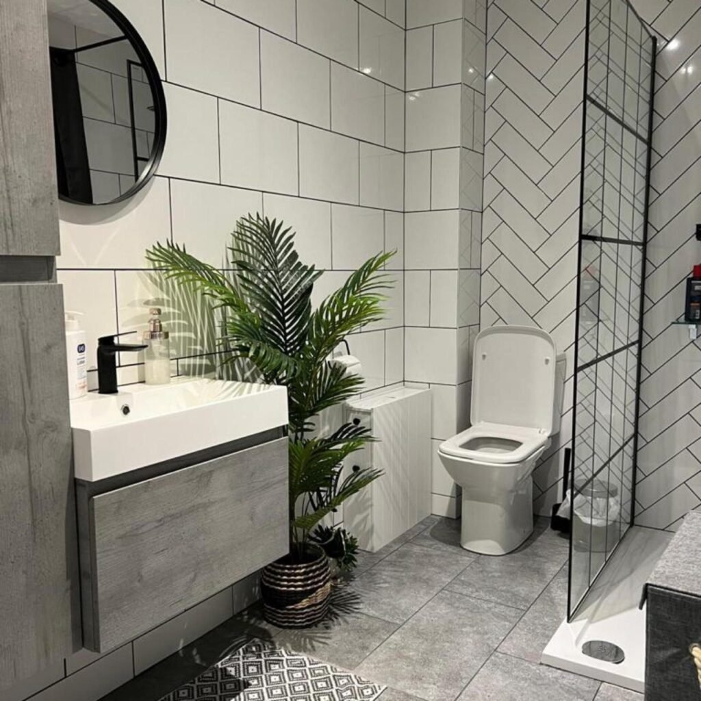 Bathroom renovation completed by TY Home Renovations with wall-mounted sink and tiled shower